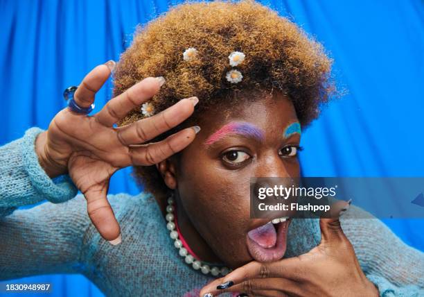 fashionable, quirky person standing in front of a  photo booth style blue curtain. - you & a stock pictures, royalty-free photos & images