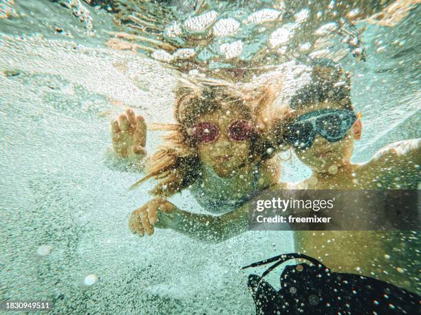 kids swimming underwater - kids underwater stock pictures, royalty-free photos & images
