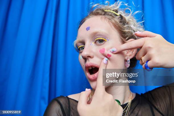 young woman wearing pimple patches. - brufolo foto e immagini stock