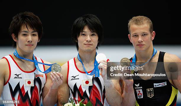 Ryohei Kato of Japan, Kohei Uchimura of Japan and Fabian Hambuechen of Germany pose with their medals after the Mens All-Around Final on Day Four of...