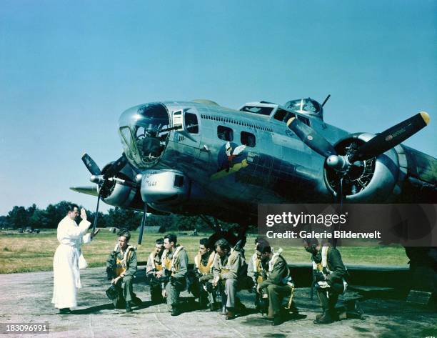 Priest leading the prayers of a B-17 Flying Fortress bomber crew at an airfield in southern England, 1944.