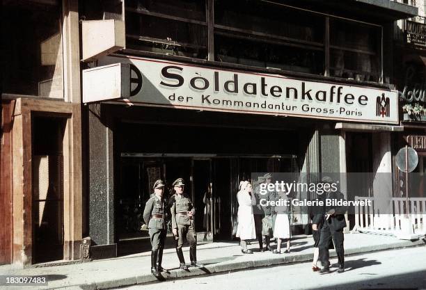 German Wehrmacht soldiers in front of the Soldatenkaffee der Kommandantur Gross-Paris , Paris, 1943. The cafe is one of many reserved for German...
