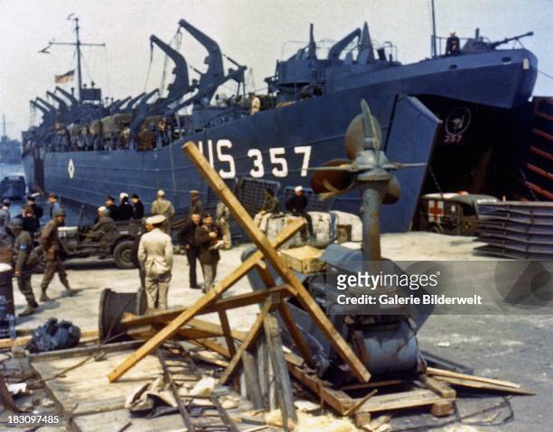 Landing Ship Tank loading an ambulance at Portland Harbour, Dorset, before the D-Day landings, 5th June 1944. It will soon depart to participate in...