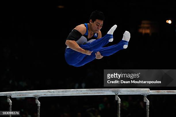 Sergio Sasaki Junior of Brazil competes in the parallel bars during the Mens All-Around Final on Day Four of the Artistic Gymnastics World...