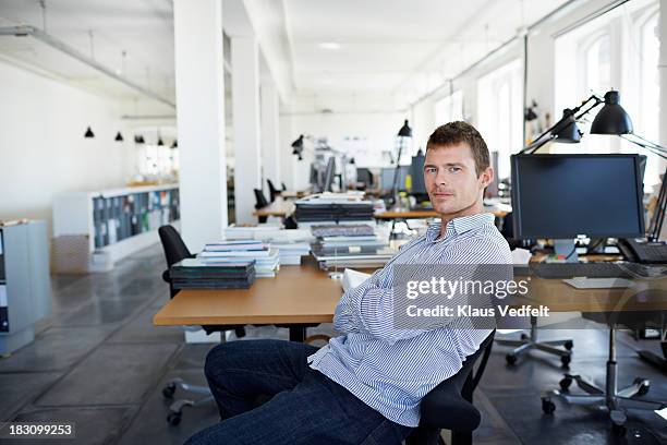 portrait of casual businessman at creative office - voorzitter stockfoto's en -beelden