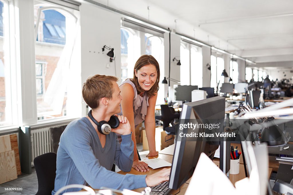 Coworkers hanging out by office desk