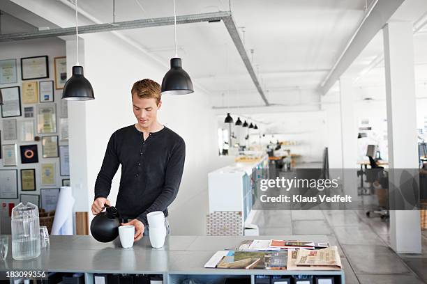 portrait of businessman having a coffee break - designer coffee table stock pictures, royalty-free photos & images