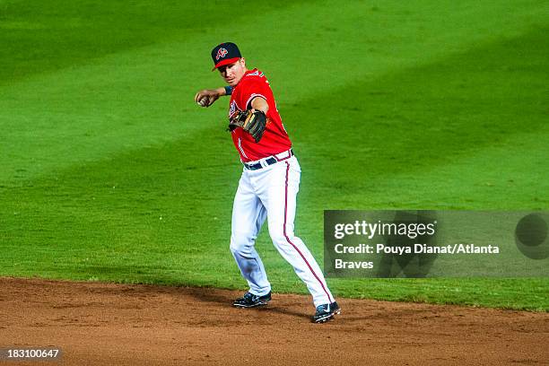 Elliot Johnson of the Atlanta Braves fields a ball against the San Diego Padres at Turner Field on September 13, 2013 in Atlanta, Georgia. The Padres...