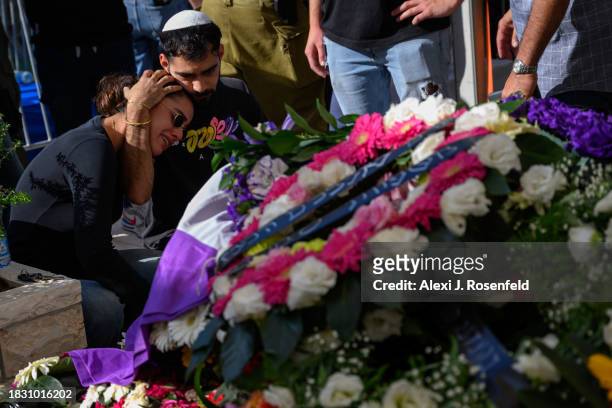 Mourners grieve for Col. Asaf Hamami, commander of Gaza Division's Southern Brigade, during his funeral at the Kiryat Shaul cemetery on December 04,...