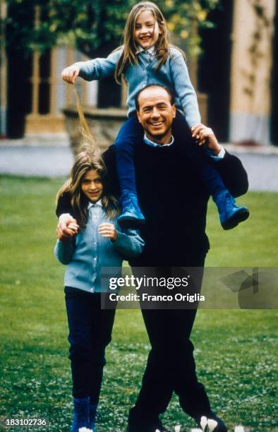 Young Silvio Berlusconi in the garden of his villa near Milan, with his daughters Barbara and Eleonora whom he had from his second wife Veronica...