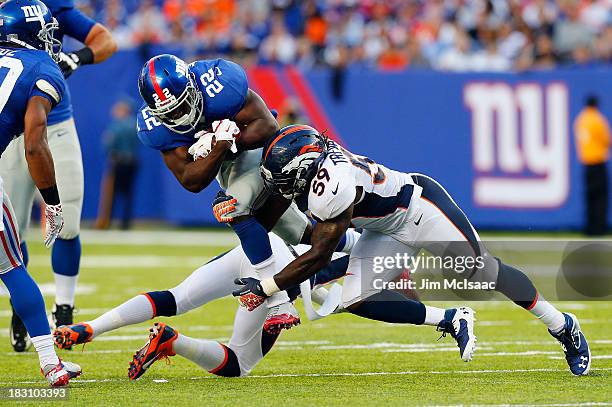 David Wilson of the New York Giants in action against Danny Trevathan of the Denver Broncos on September 15, 2013 at MetLife Stadium in East...