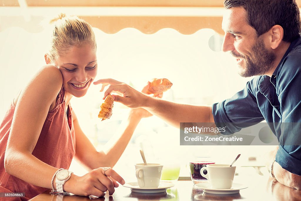 Young couple has breakfast at italian café