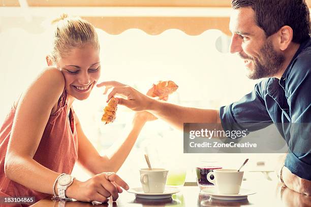 young couple has breakfast at italian café - blond women happy eating stock pictures, royalty-free photos & images