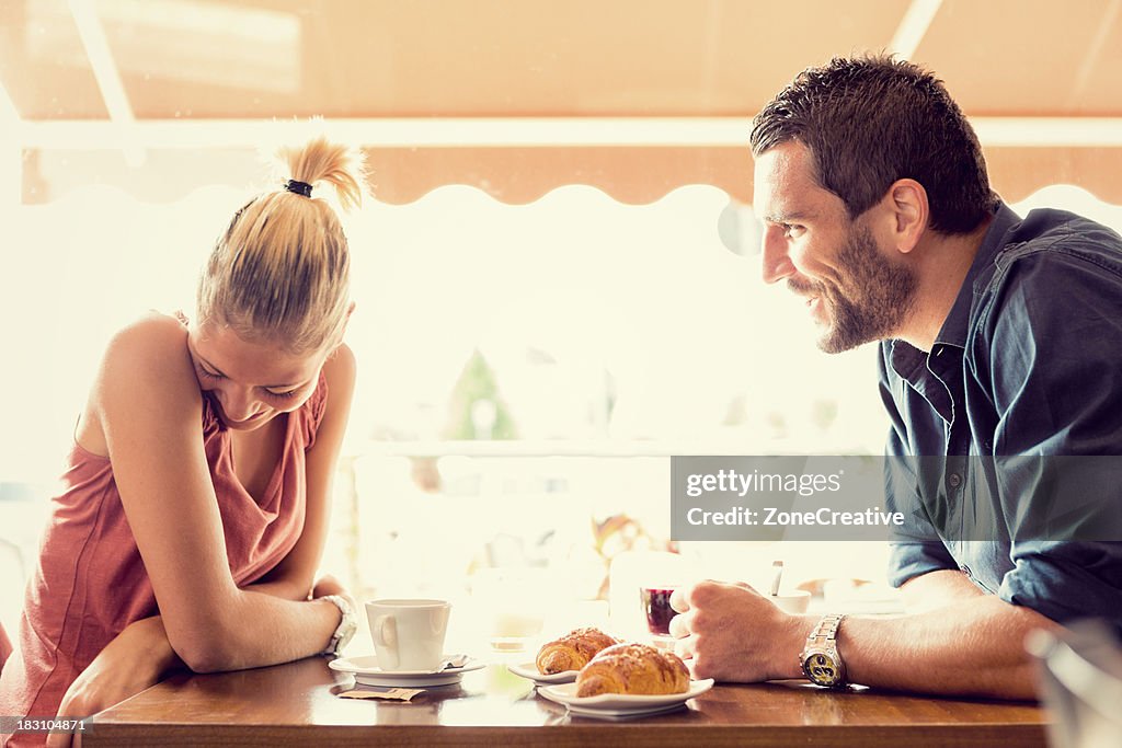 Young couple has breakfast at italian café