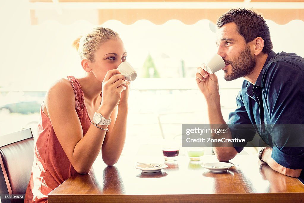 Young couple drink coffee at italian café