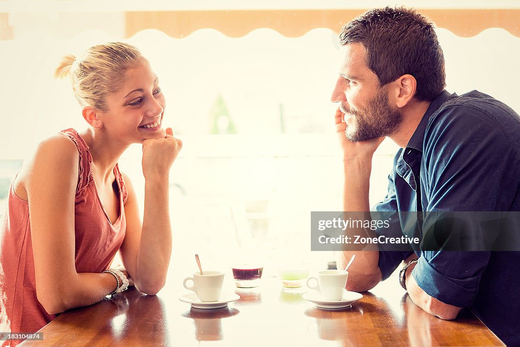 Young couple has breakfast at italian café