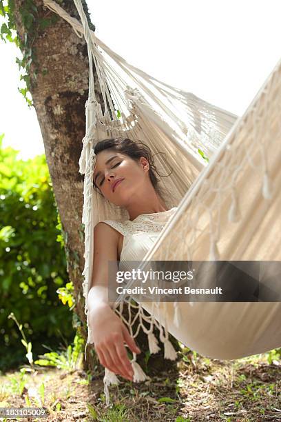 young woman relaxing in a hammock - hammock stock pictures, royalty-free photos & images