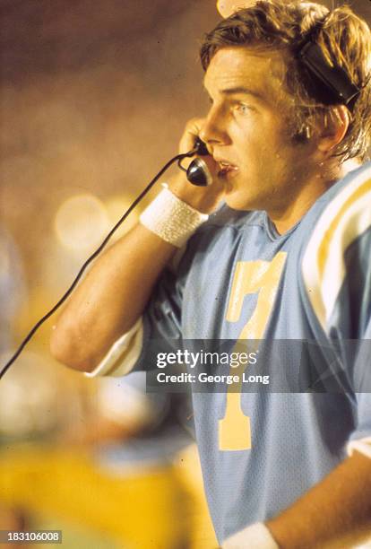 Closeup of UCLA QB Mark Harmon on the phone on the sidelines during game vs Nebraska at Rose Bowl Stadium. Pasadena, CA 9/9/1972 CREDIT: George Long
