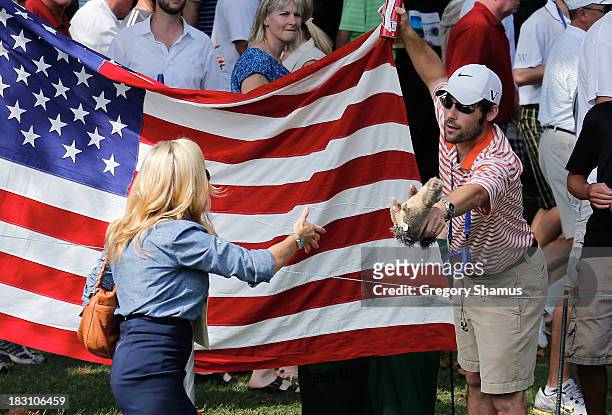 Fan offers a toy squirrel to Amy Mickelson of the U.S. Team on the second hole during the Day Two Foursome Matches at the Muirfield Village Golf Club...