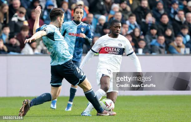 Ousmane Dembele of PSG, left Gautier Lloris of Le Havre in action during the Ligue 1 Uber Eats match between Le Havre AC and Paris Saint-Germain at...