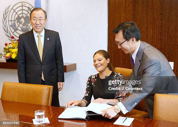 United Nations Secretary General Ban Ki-moon and United Nations Chief of Protocol Yoon Yeocheol look on as Crown Princess Victoria Of Sweden signs...