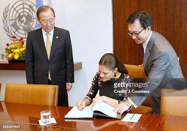 United Nations Secretary General Ban Ki-moon and United Nations Chief of Protocol Yoon Yeocheol look on as Crown Princess Victoria Of Sweden signs...