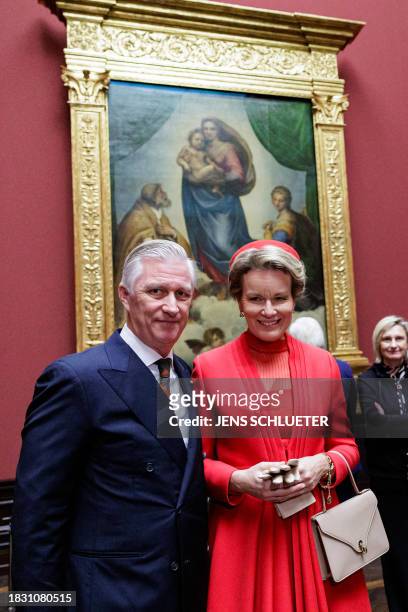 King Philippe - Filip of Belgium and Queen Mathilde of Belgium pose in the front of the painting "Sistine Madonna" by 16th century Italian artist...
