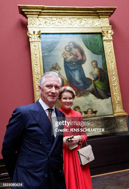 King Philippe - Filip of Belgium and Queen Mathilde of Belgium pose in the front of the painting "Sistine Madonna" by 16th century Italian artist...