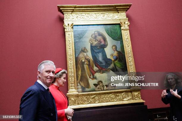 King Philippe - Filip of Belgium and Queen Mathilde of Belgium pose in the front of the painting "Sistine Madonna" by 16th century Italian artist...