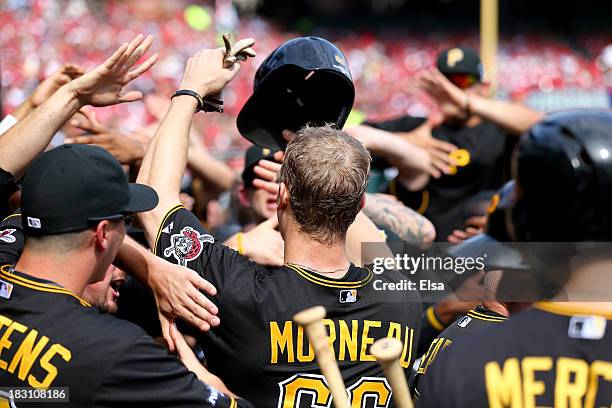 Justin Morneau of the Pittsburgh Pirates is greeted in the dugout after scoring in the fifth inning against the St. Louis Cardinals during Game Two...