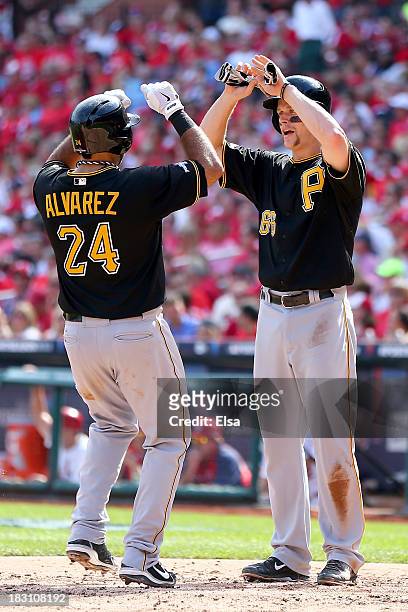 Pedro Alvarez of the Pittsburgh Pirates hits a two-run home run in the third inning and celebrates with Justin Morneau against the St. Louis...