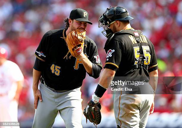 Gerrit Cole talks with catcher Russell Martin of the Pittsburgh Pirates in the sixth inning against the St. Louis Cardinals during Game Two of the...