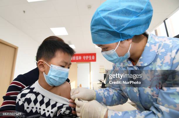 Medical worker is giving a child a flu vaccine at a community health service center in Guiyang, Guizhou Province, China, on December 7, 2023.