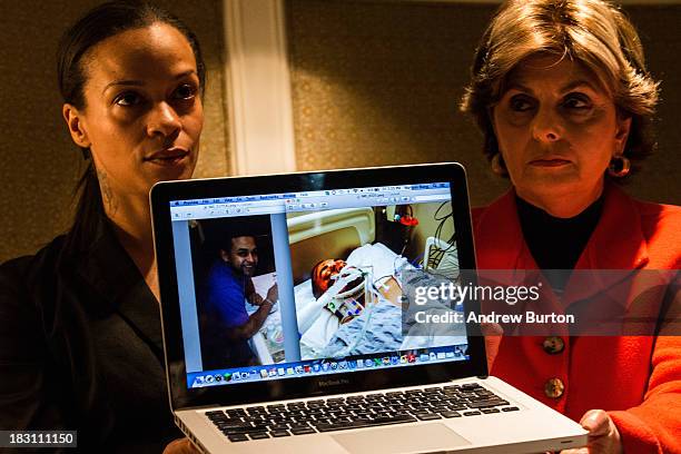 Attorney Gloria Allred , who is representing the family of Edwin Mieses Jr.,and Dayana Mejia , wife of Mieses, show photos of Mieses at a press...