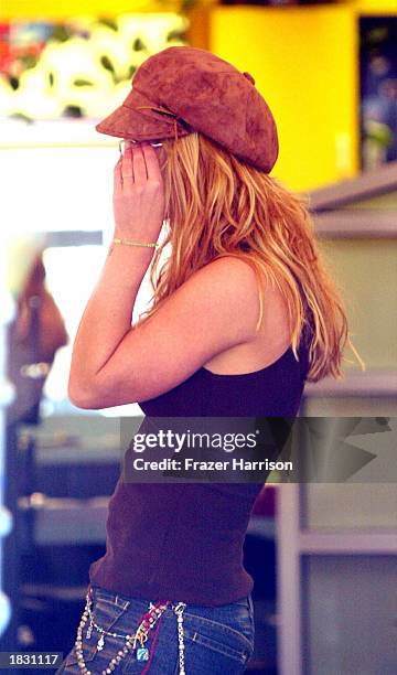 Singer Britney Spears shops for eyeglasses on Melrose Avenue on March 5, 2003 in Los Angeles, California.