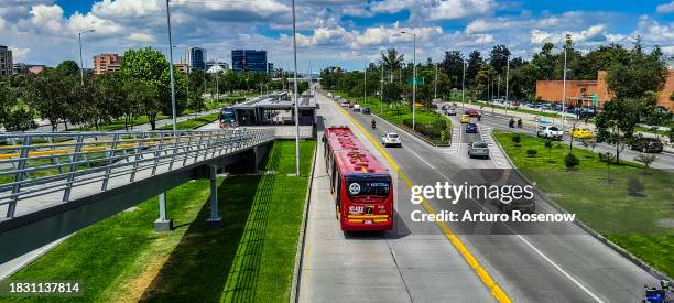 cars and bus on a street with buildings in the background - bogota stock pictures, royalty-free photos & images