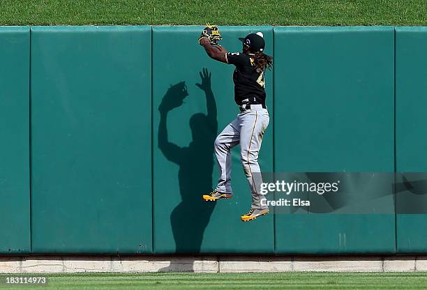Andrew McCutchen of the Pittsburgh Pirates is unable to make a catch on a ball hit by Matt Adams of the St. Louis Cardinals in the ninth inning...