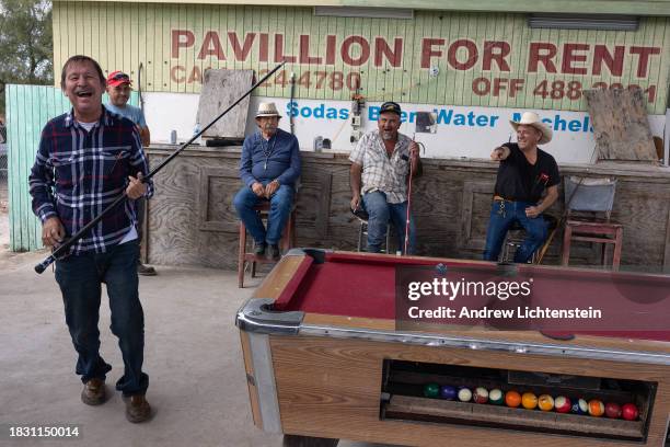 Men play a game of pool at a local weekend flea market, December 2 in Rio Grande City, Starr County, Texas. The vast majority of rural Starr County,...