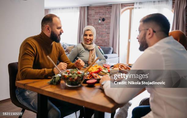 celebrating ramadan with our friends - arab-family-iftar stock pictures, royalty-free photos & images
