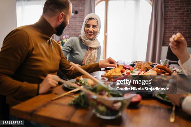 young happy muslim woman enjoying in ramadan meal with her friends - ramadan bildbanksfoton och bilder