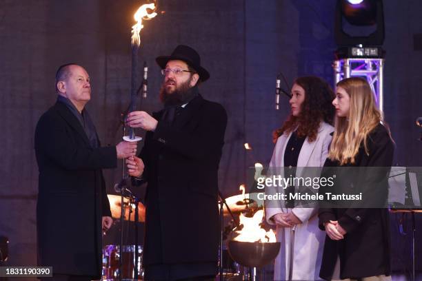 German Chancellor Olaf Scholz and Rabbi Yehuda Teichtal together with Na'ama and Ofir Weinberg inaugurate a giant, illuminated menorah to celebrate...