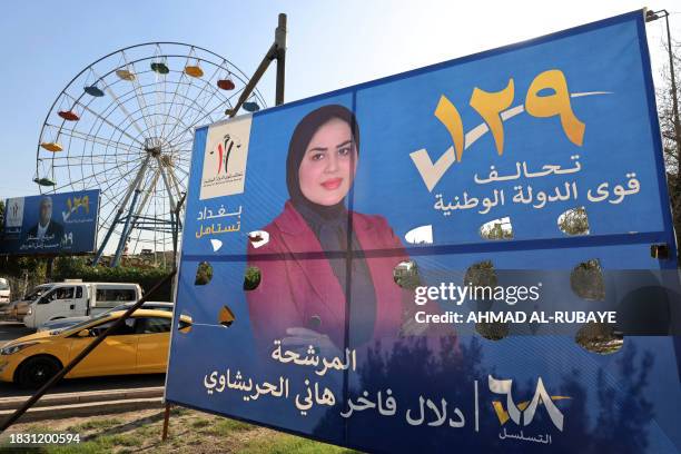 Electoral billboards are set up in Baghdad on December 7 as Iraqis prepare to vote on December 18 to select councils in more than a dozen provinces,...