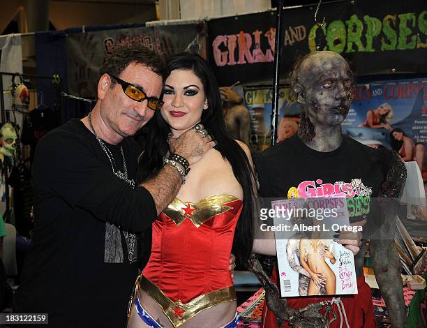 Publisher Robert Rhine and adult film star Kendall Karson sign autographs at the Girls & Corpses booth on Day 2 of the 2013 Comic-Con International -...