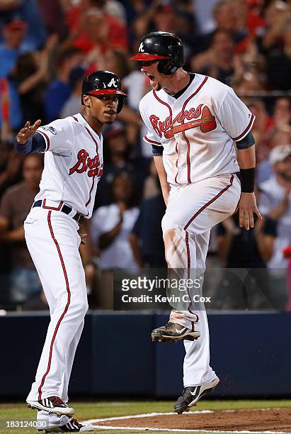 Upton and Chris Johnson of the Atlanta Braves celebrate after scoring in the seventh inning against the Los Angeles Dodgers during Game Two of the...