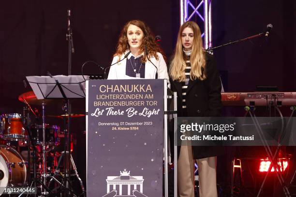 Na'ama Weinberg and Ofir Weinberg speak as they inaugurate a giant, illuminated menorah to celebrate the beginning of Hanukkah on December 7, 2023 in...