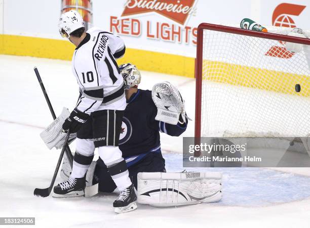 Puck flies in behind Ondrej Pavelev of the Winnipeg Jets as Matt Greene of the Los Angeles Kings gets the first goal of the game in first period...