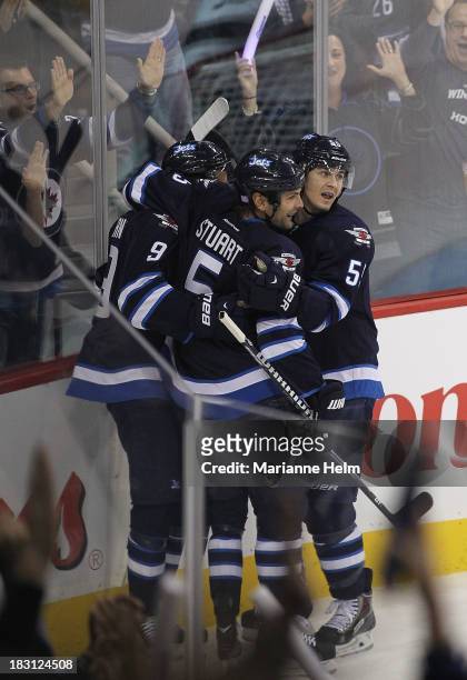 Mark Scheifele and Mark Stuart of the Winnipeg Jets congratulate teammate Evander Kane for his goal against the Los Angeles Kings in first period...