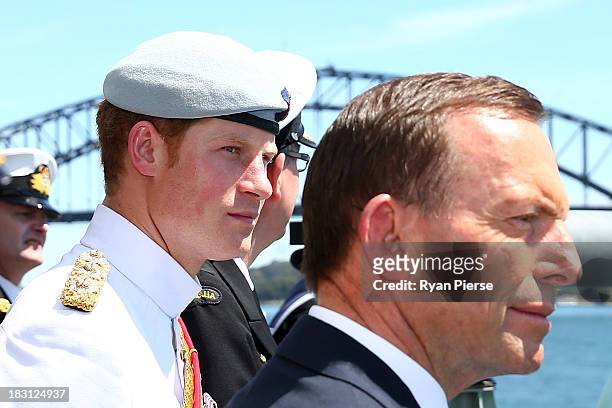 Prince Harry and Australian Prime Minister Tony Abbott view Sydney Harbour as they participate in the 2013 International Fleet Review onboard the...