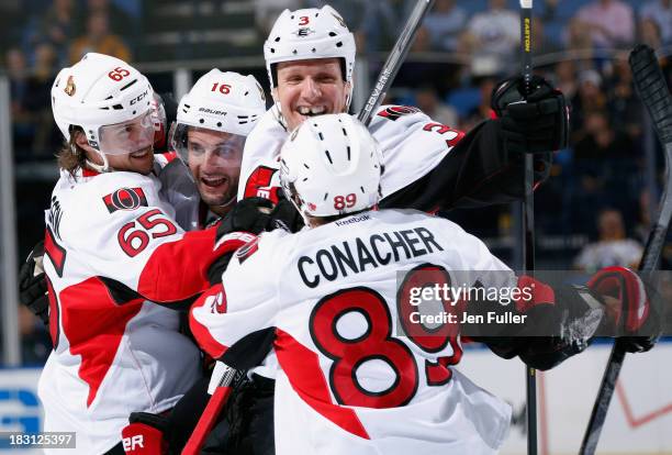 Erik Karlsson of the Ottawa Senators celebrates his game winning third period goal against the Buffalo Sabres with teammates Clarke MacArthur, Marc...