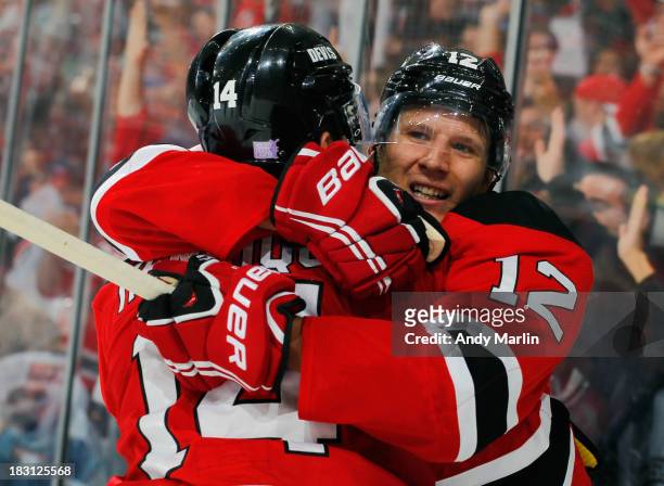 Damien Brunner of the New Jersey Devils celebrates with teammate Adam Henrique after scoring his second goal of the game during the third period...